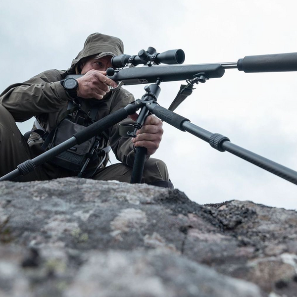 man taking a shot with sniper with stand