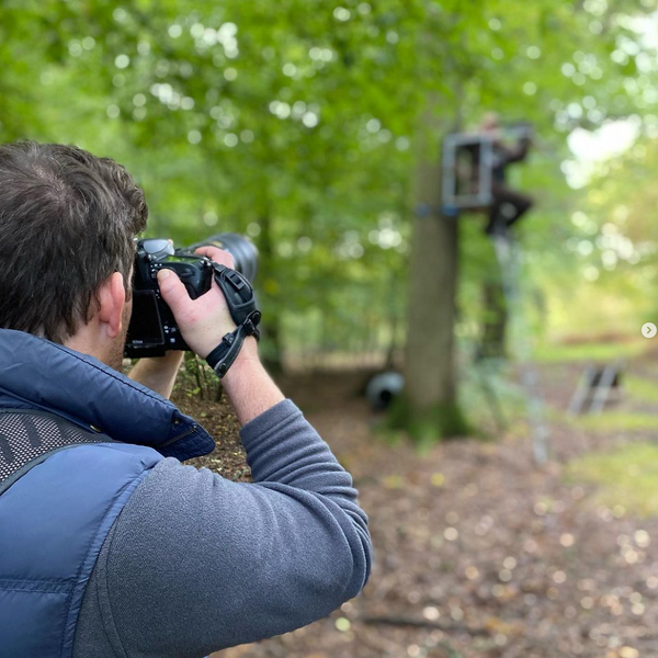 man holding camera and taking shots